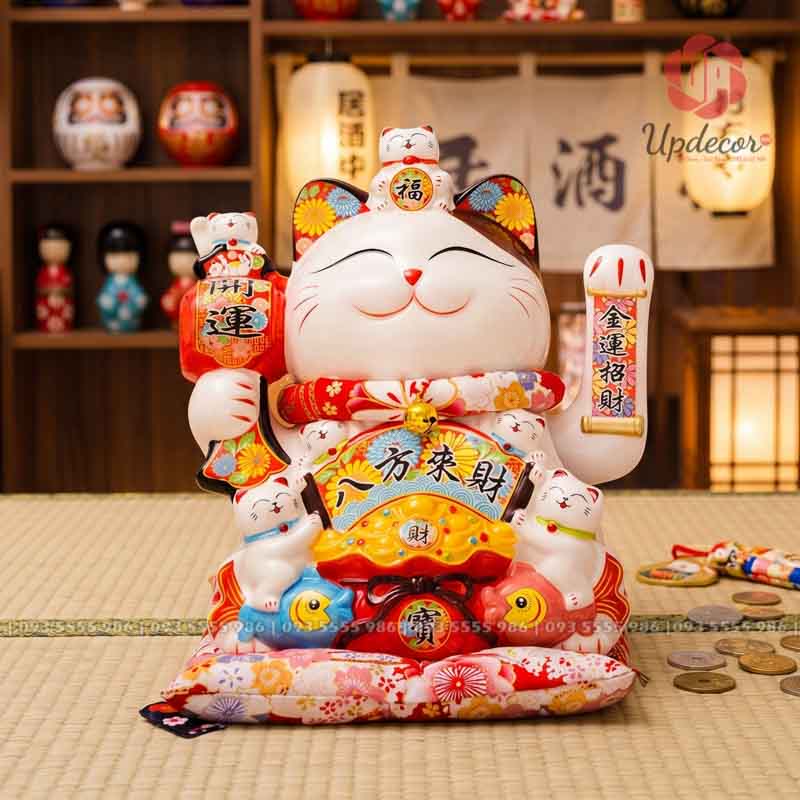 Mèo Thần Tài Vẫy Tay Nhật Bản Maneki Neko Mã UP019 Đây là mẫu mèo thần tài gốm sứ có dáng ngồi bề thế, thân trắng bóng, gương mặt hiền, tay vẫy chiêu tài, nhiều mèo con may mắn và họa tiết hoa rực rỡ. Sản phẩm mang cảm giác sung túc, sáng màu, rất hợp đặt tại quầy thu ngân, cửa hàng, văn phòng hoặc làm quà khai trương trang trọng