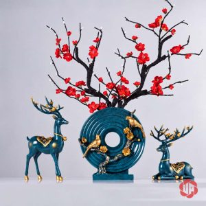 Tượng vòng tròn xanh ngọc phối cành hoa đỏ, hươu đứng bên trái và hươu nằm bên phải