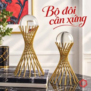 Quả cầu thủy tinh chân vàng bày cùng sách màu đen
