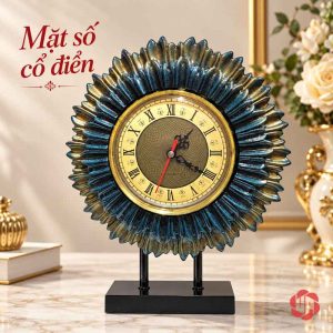 Đồng hồ để bàn tạo hình mặt trời xanh phối vàng với mặt số La Mã và chân đế đen