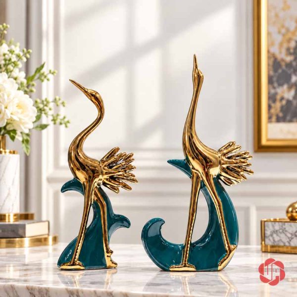Cặp tượng chim hồng hạc ánh vàng trên phần đế xanh, một dáng cổ cong và một dáng vươn cao