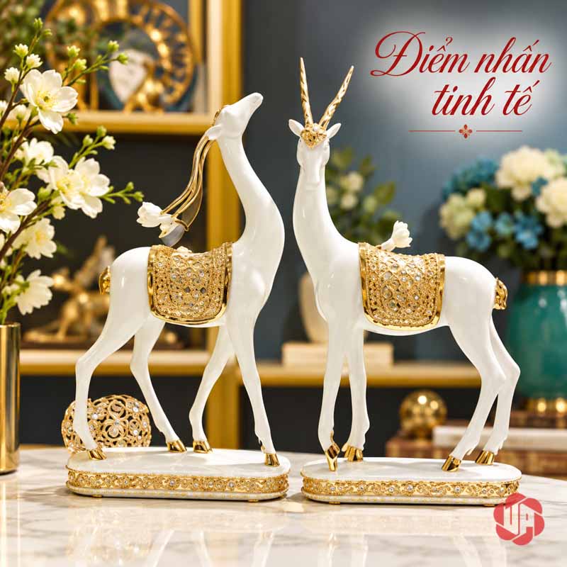Đôi Tượng Dê Nghệ Thuật Trắng Vàng UPV064 Hai tượng dê đứng cạnh cành hoa trắng trên bàn sáng