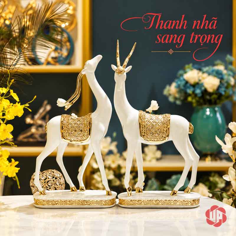 Đôi Tượng Dê Nghệ Thuật Trắng Vàng UPV064 Đôi dê trắng vàng trên mặt đá trước nền kệ tối